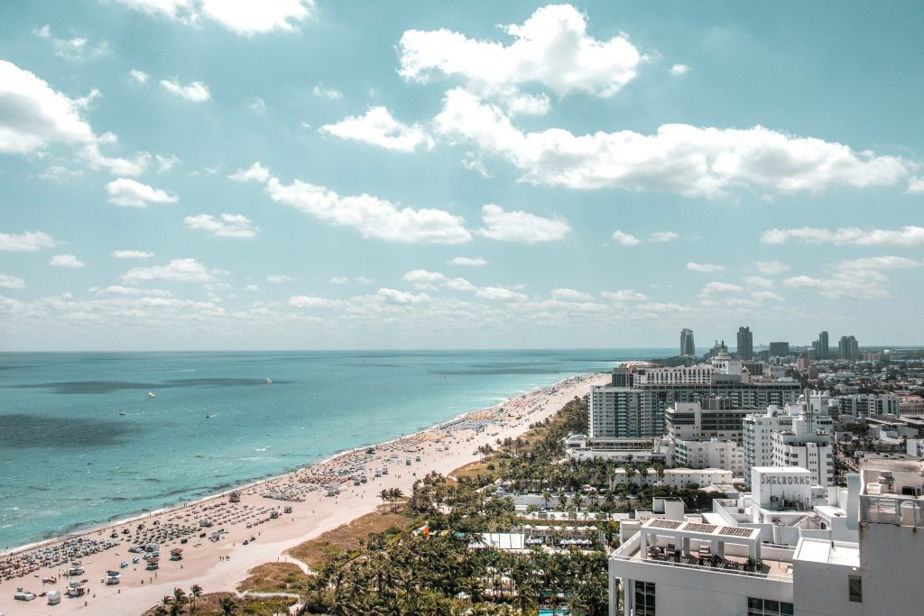 A wide beach with hotel and apartment blocks along it