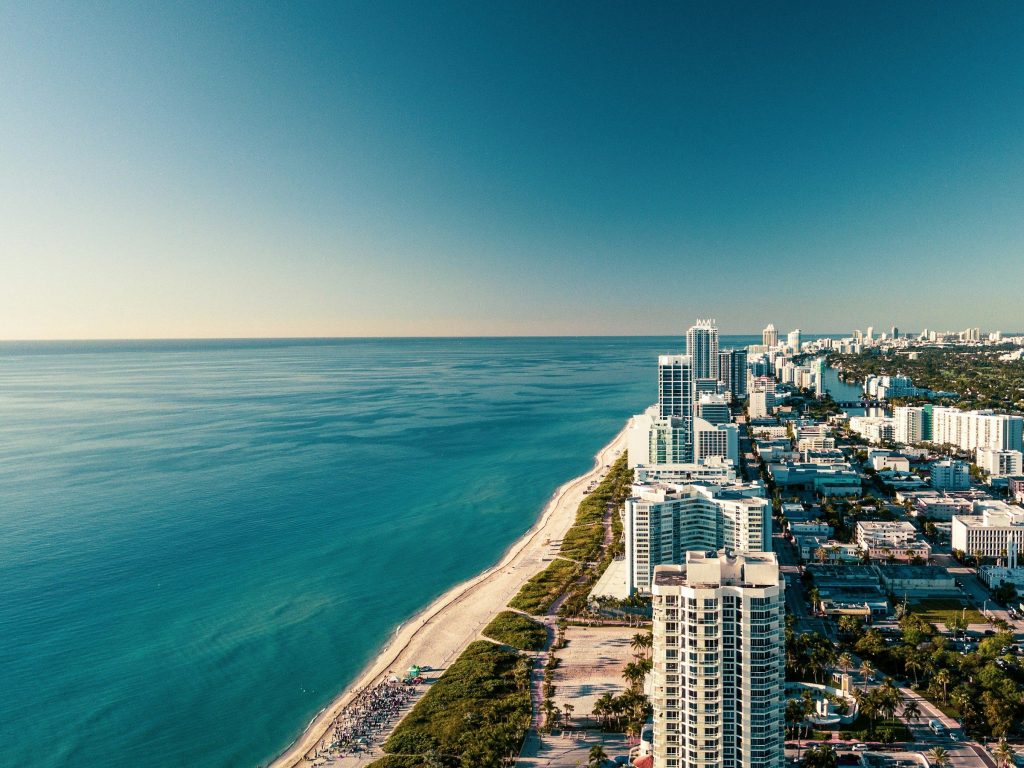 A strip of beach towers between the ocean and the bay, from the air