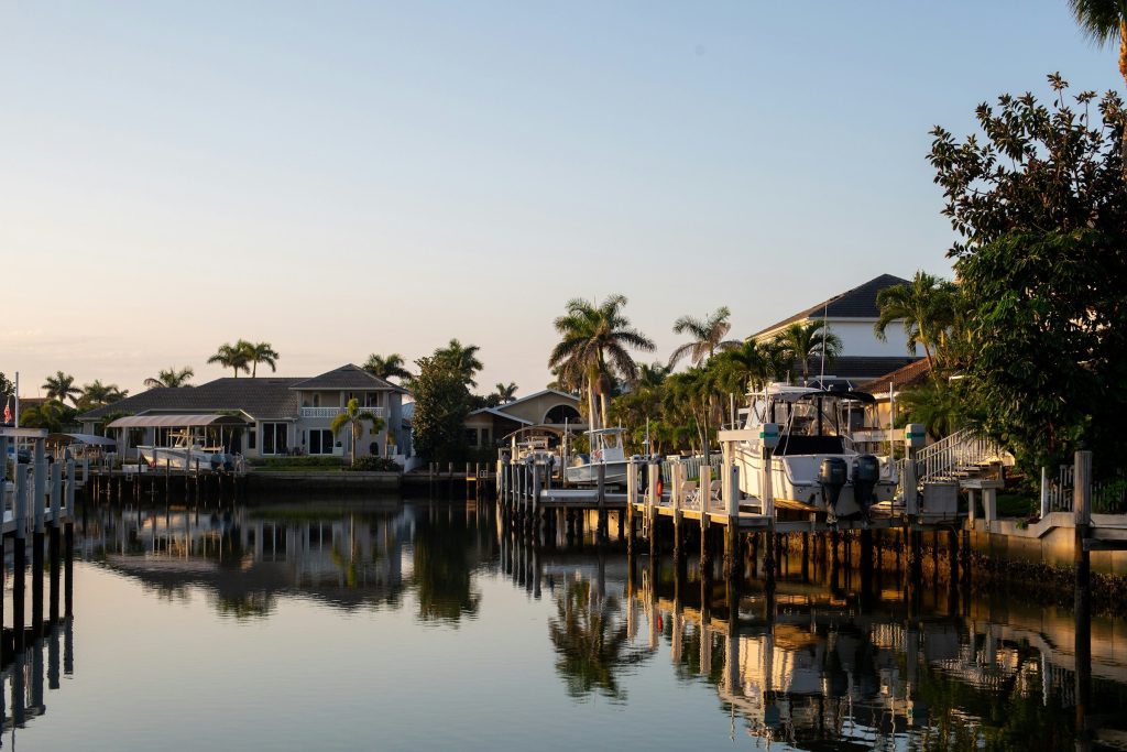 Houses along a canal at the end of the day, boats on their lifts