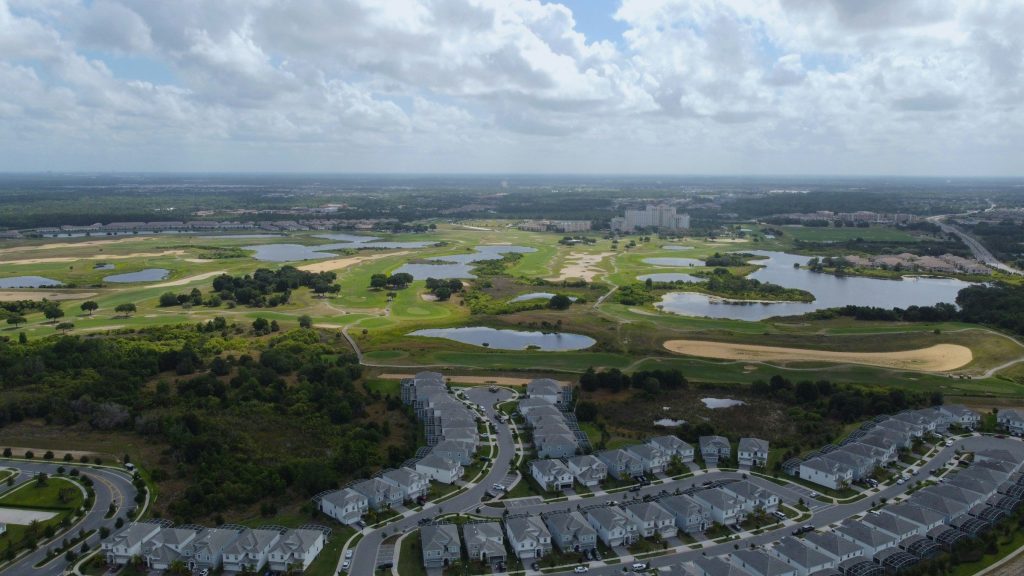 Townhouses along the edge of a golf course and its lakes
