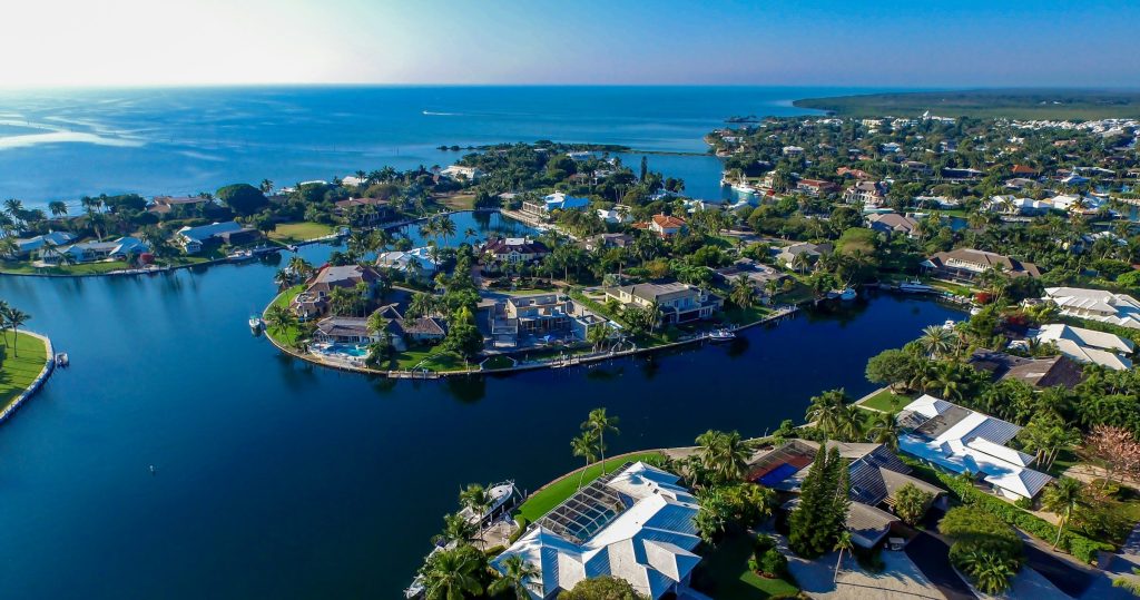 An island neighborhood of waterfront houses seen from the air