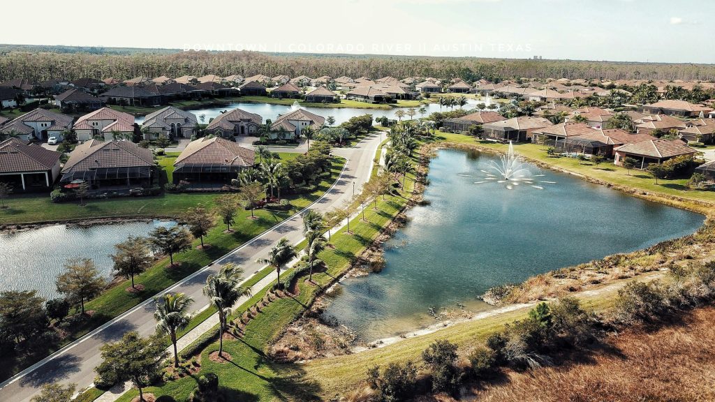 A community built along a fountain lake, one house type repeated