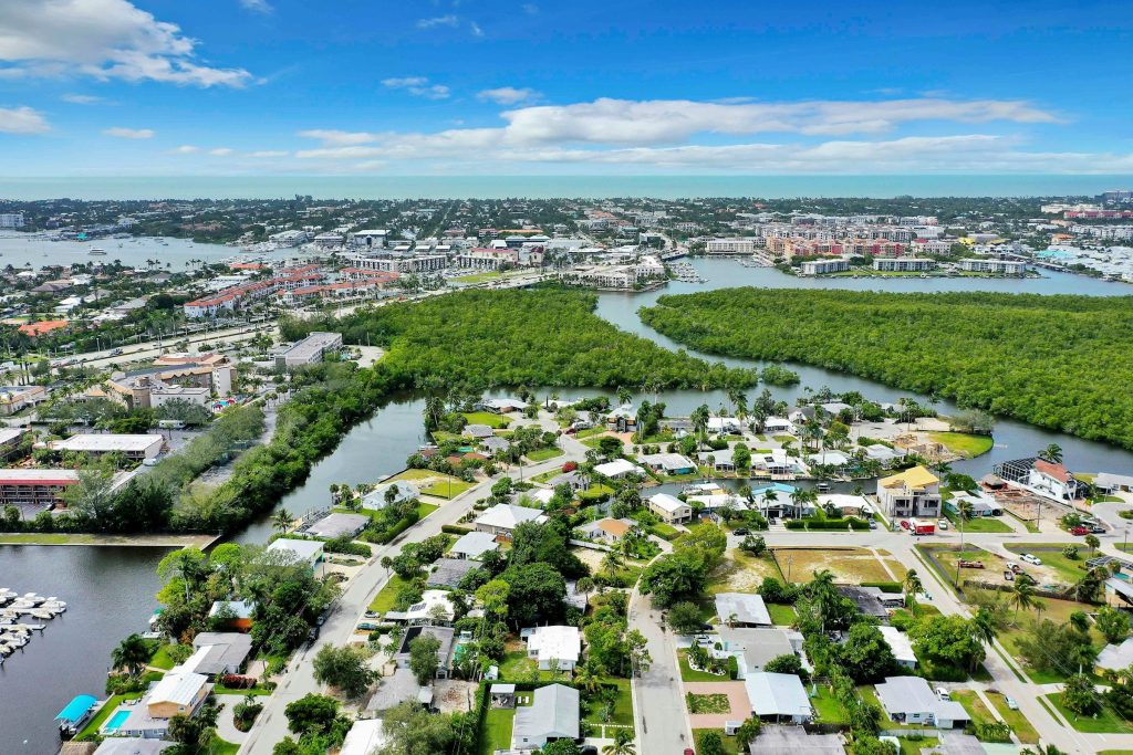 A low-rise neighborhood between mangrove creeks and a marina