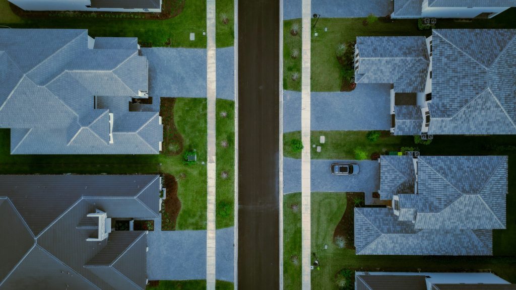 Two rows of houses and their drives, straight down