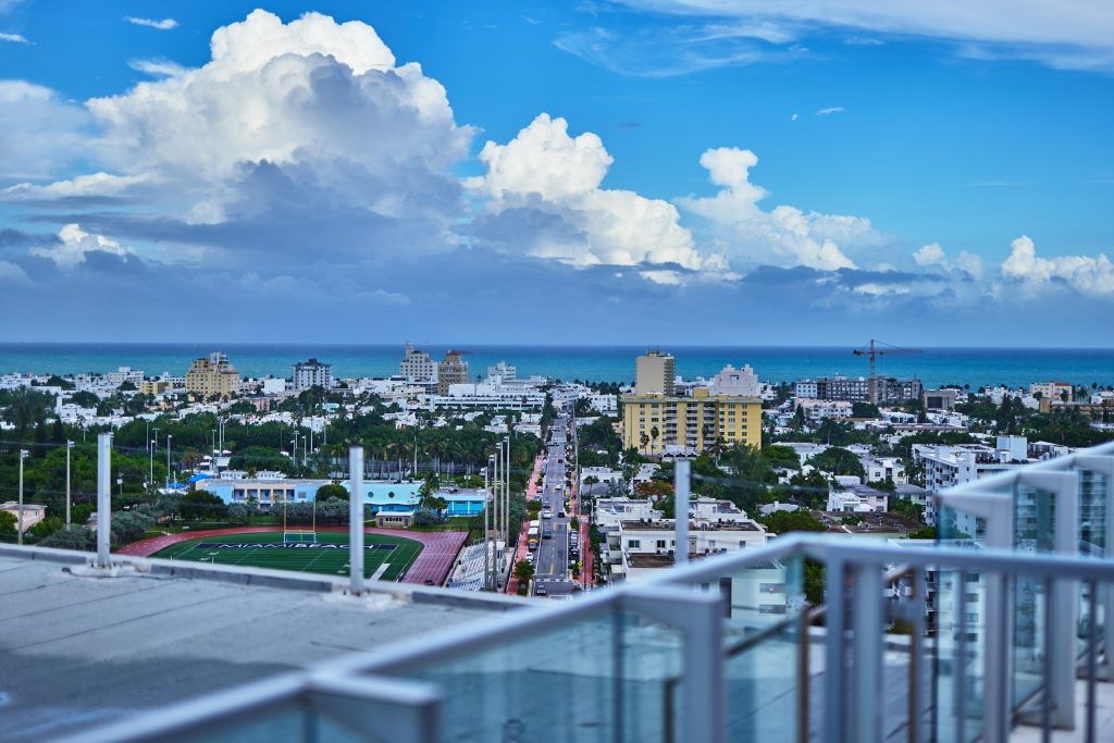A low-rise beach town seen over a rooftop railing