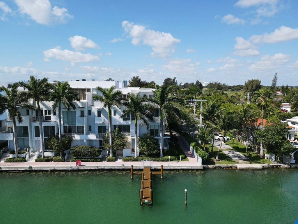 White waterfront townhouses with a shared dock on the intracoastal