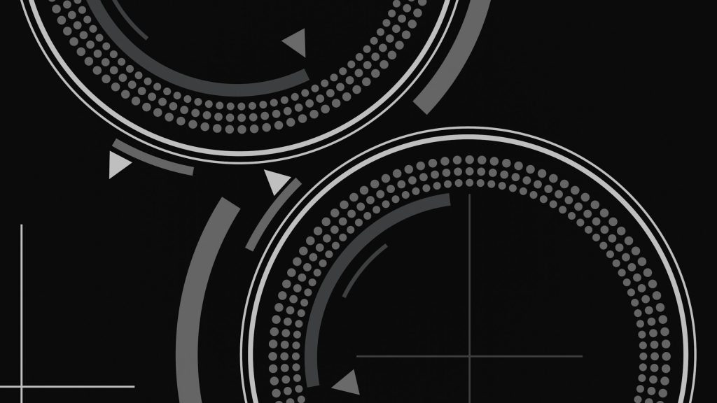 The etched zone markings and slider of an induction hob on black glass