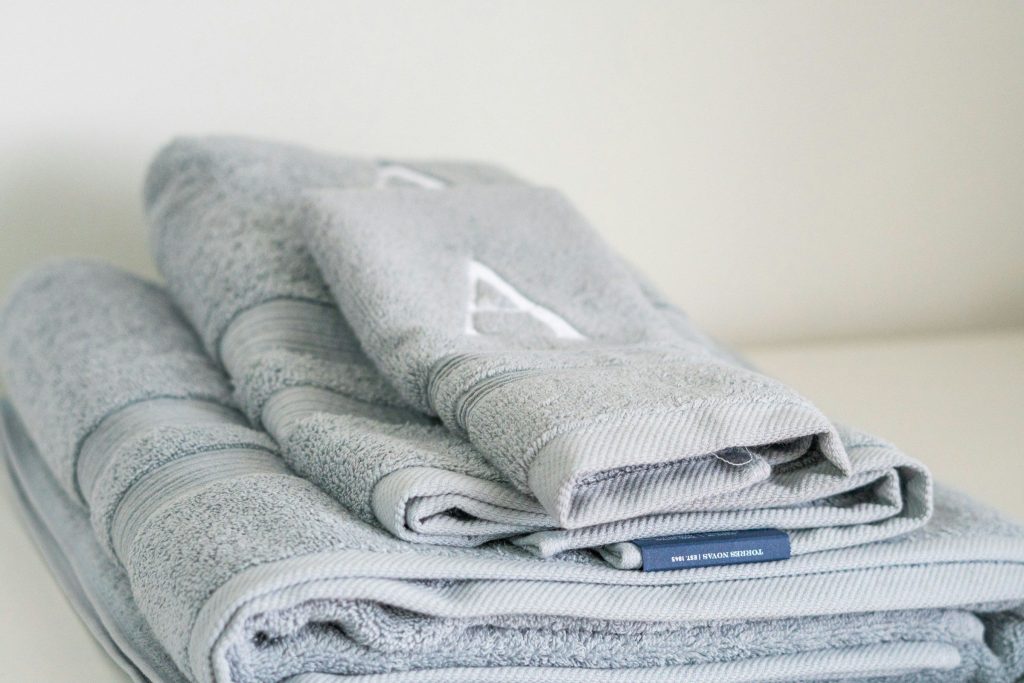 Folded grey towels in a neat stack