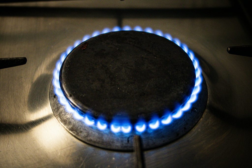 A heavy pan sitting on a lit gas ring, seen from above